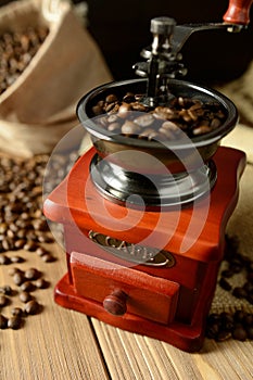 Coffee mill and coffee beans on dark background