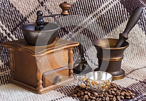 Coffee mill, cup and coffee beans