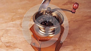 A coffee mill filled with coffee beans. Coffee grinder with coffee beans.