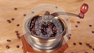 A coffee mill filled with coffee beans. Coffee grinder with coffee beans.