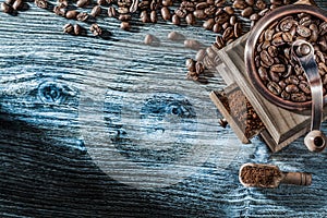 Coffee mill roasted grains scoop on wooden board