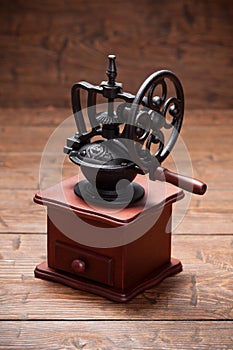 Coffee mill on rustic old wooden table