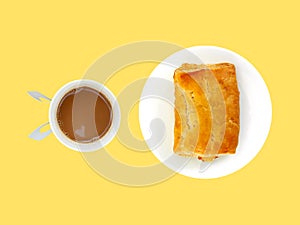 coffee with mini heart reflecting in disposable cup and rectangle golden crispy pie on white ceramic dish