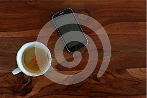 Coffee and Mobile Phone on the wooden table