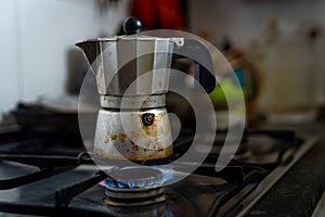 A coffee moka is seen on top of a kitchen stove with a blue gas flame. Due to Russia`s invasion of Ukraine gas prices have reache