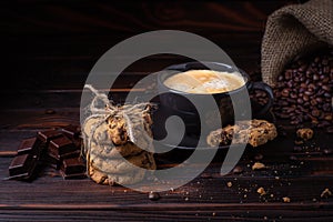 Coffee mood.dark background. coffee, cookies chocolate and crumbled coffee beans