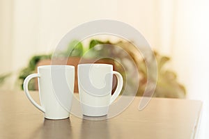 Coffee in the morning, two white tea cup mug placed on wooden table at home
