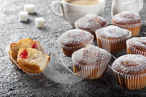 Coffee muffins on a wooden Board. Sweet muffins with berry filling on the table.
