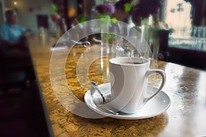 A coffee mug on a bar table.