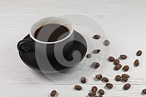 Coffee mug and coffee breans on wood backgound
