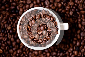 Coffee mug filled with coffee beans and coffee background