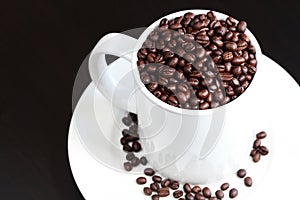 Coffee mug filled with fresh coffee beans