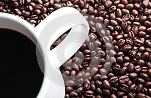 Coffee mug on fresh coffee beans