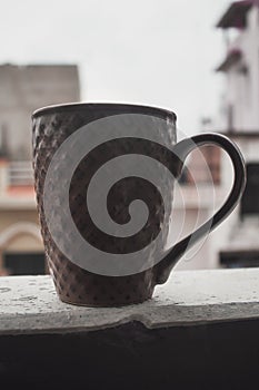 Coffee mug on terrace railing