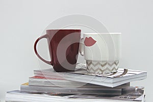 Coffee mug on top of magazine pile