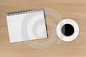 Coffee and notebook on the wood background