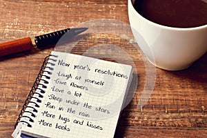 Coffee and notepad with a list of new years resolutions