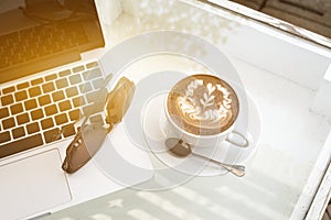 Coffee with open up laptop and sunglasses on table,business concept