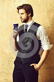 Coffee paper cup in hand of business man in suit