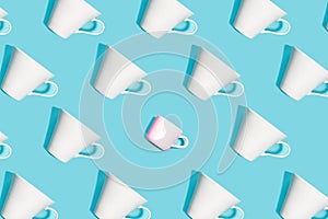 Coffee pattern of white ceramic cups for coffee on bright blue background.