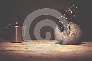 Coffee percolator, black grapes on wooden table, copy space.