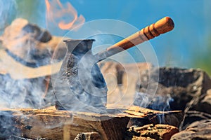 Coffee percolator on a campfire at morning