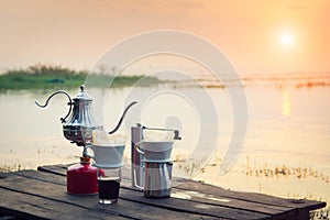 Coffee percolator on a campfire at morning photo