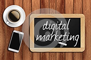 Coffee, phone and chalkboard with digital marketing words