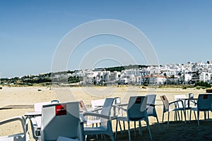 Coffee place with white chairs and table in a small town in southern spain, at the seaside of the mediterranean