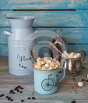 Coffee with a plentiful marshmallow slide and chocolate. Floral blue flower pots and sugar bowl with marshmallows photo