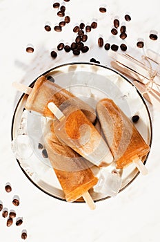 Coffee Popsicles, Refreshing Ice Lollies with Coffee Beans and Ice on Bright Background