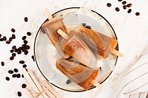 Coffee Popsicles, Refreshing Ice Lollies with Coffee Beans and Ice on Bright Background