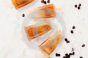 Coffee Popsicles, Refreshing Ice Lollies with Coffee Beans and Ice on Bright Background