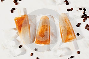 Coffee Popsicles, Refreshing Ice Lollies with Coffee Beans and Ice on Bright Background