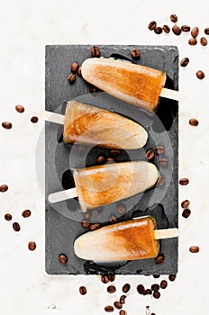 Coffee Popsicles, Refreshing Ice Lollies with Coffee Beans and Ice on Bright Background