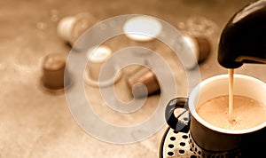 Coffee pouring into a cup from a pod coffee machine