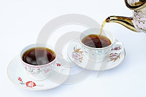 The coffee is pouring into the cup.