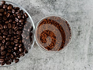 Coffee powder in bowl with defoused beans in saucer