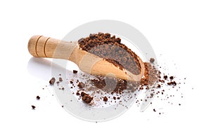 Coffee powder in wooden scoop isolated on white