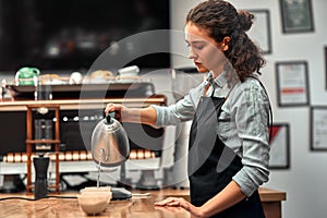 Coffee professional q grader testing and inspecting the quality of arabica coffee beans. offee grounds in a cup on the table. Side