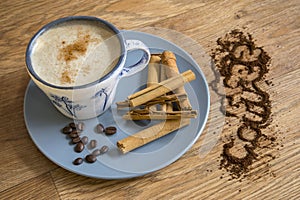 Coffee, roast beans and cinnamon sticks.