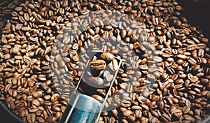 Coffee roasting proces in the machine roastery photos illustration