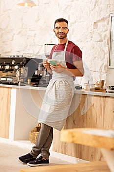 Prosperous businessman drinking coffee in his coffee room photo