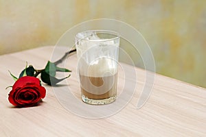 Coffee and rose on table