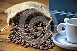 Coffee sack, with espresso coffee and an old blue grinder