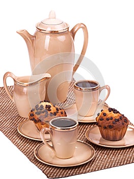 Coffee service and muffins on a plate on white isolated