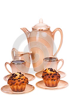 Coffee service and muffins on a plate on white isolated