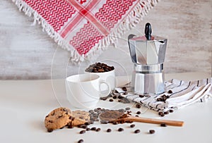 Coffee set of espresso boiler with grounded and beans of coffee on white background with arabick shmagh photo
