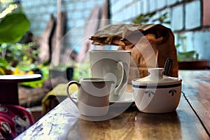 Coffee set and paper pack on table