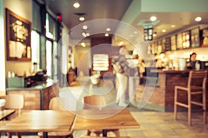 Coffee shop and people sit on table. Blur background